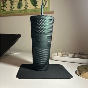 Dark green studded Starbucks cup